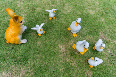 Artificial sculptured ducks and rubbit garden decoration on the grassの写真素材