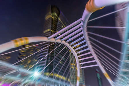 The architectural design of the skywalk above the intersection on Sathorn road in bustling Bangkok,...
