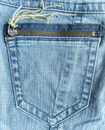 Back pocket with zipper and the texture of blue denim jeans for background useの写真素材