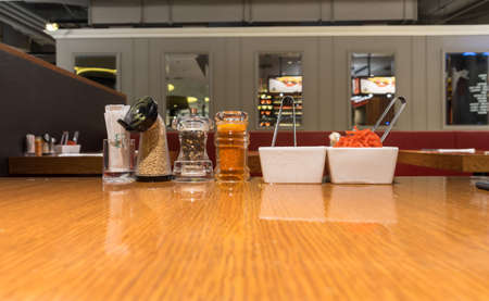 Ingredients and condiments of Japanese ramen on the table. White sesame, pepper, grounded chilli, garlic, and pickled gingerの写真素材