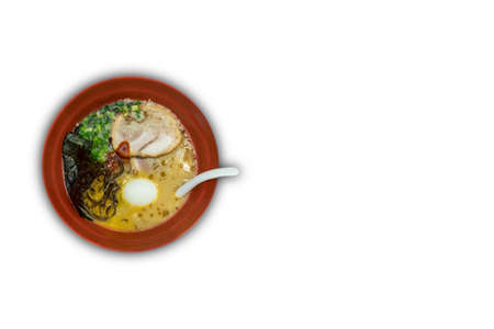 Red bowl of delicious tonkatsu (pork bone soup) ramen with egg, seaweeds and spring onion. Isolated white backgroundの写真素材