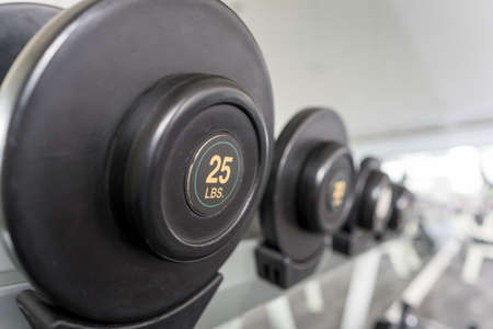 25lbs dumbbell on a rack in the fitness room, shallow DOFの写真素材