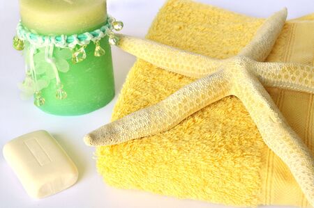 Close-up of towel, soap, starfish and candle.の写真素材