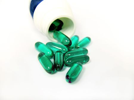 Close up of medicine green capsules and plastic bottle on white background.
の写真素材
