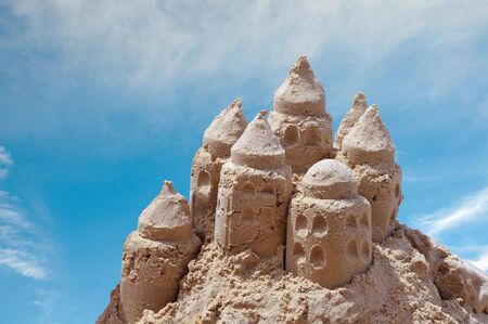 Sand castle on blue sky backgroundの写真素材