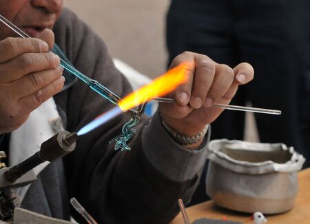 Close-up of creating deer glass figure.の写真素材