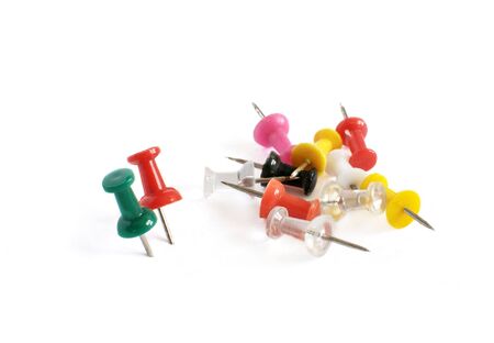 Close-up of few colorful thumbtack isolated on white background.