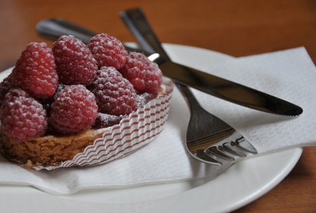 Closeup view of a raspberry cake on white plate 