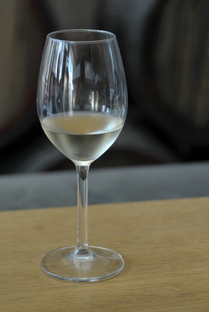 View of a glass with white wine placed on a wood table の写真素材