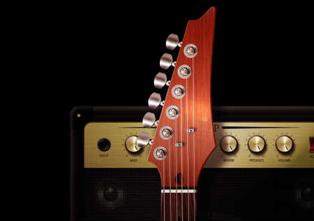 Close up of strut and controls on electric guitar with amplifier.