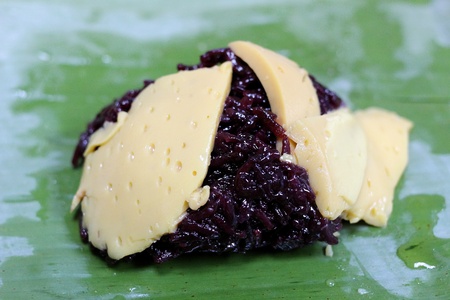 Thai dessert, Steamed sticky rice with egg custard, wrapped in banana leavesの写真素材