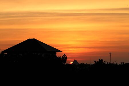 Silhouette house with sunset sky backgroundの写真素材