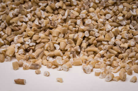 Steel ground oats close up on white background.の写真素材