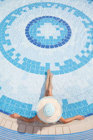 Women relaxing in pool. Top view of women sunbathing in poolの写真素材