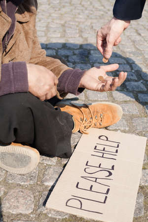 Tramp. Close-up of man giving money to tramp