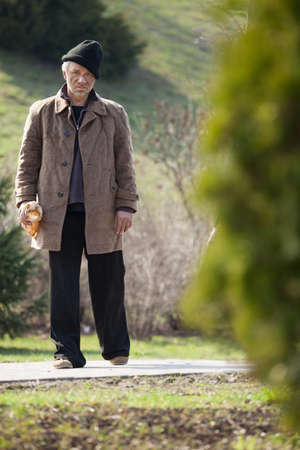 Homeless man. Full length of depressed homeless man looking at cameraの写真素材