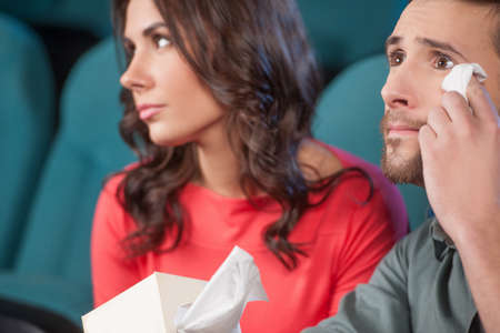 What a wonderful movie! Young couple watching movie at the cinema