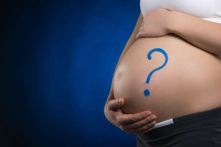 Pregnancy. Close-up of pregnant woman touching her abdomen