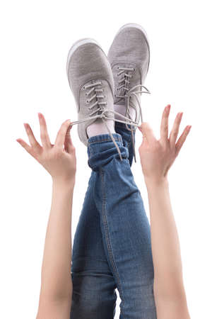 Feet up. Close-up of female legs in shoes isolated on whiteの写真素材