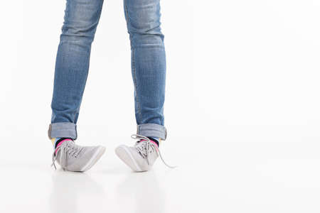 Legs. Close-up of female legs in shoes isolated on whiteの写真素材