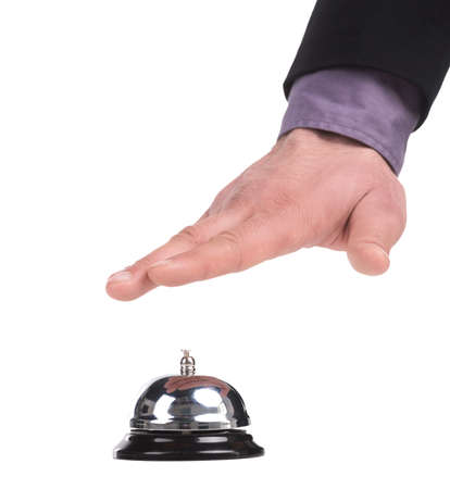 Service bell. Close-up of man holding hand upon the service bell while isolated on whiteの写真素材