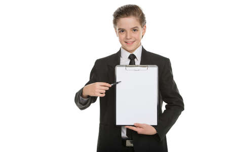 Little businessman with clipboard. Cheerful little boy in formalwear holding clipboard and pointing it while standing isolated on whiteの写真素材