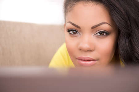 Beautiful girl. Beautiful African descent women looking at camera and smilingの写真素材