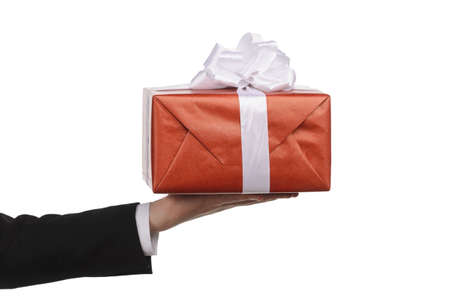 Human hand holding a gift box against white backgroundの写真素材