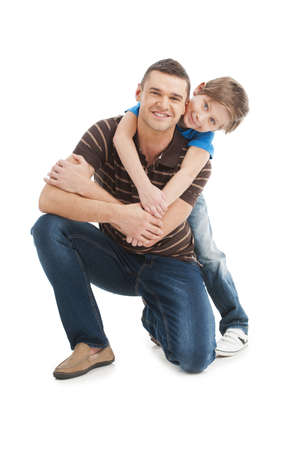 Father and son. Cheerful father and son standing close to each other and smiling while isolated on whiteの写真素材