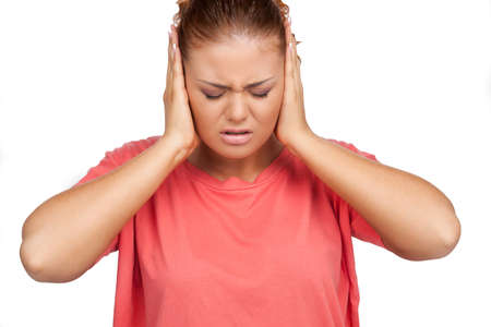 Depressed woman. Sad young woman holding head in hands while isolated on white