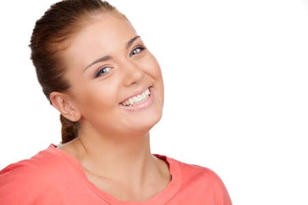 Cheerful girl. Beautiful young woman smiling while isolated on whiteの写真素材