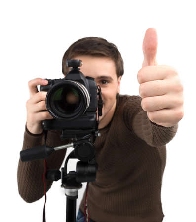 Man with camera. Cheerful young man holding camera and gesturing while standing isolated on whiteの写真素材