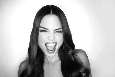 Black and white image of beautiful young women grimacing on camera