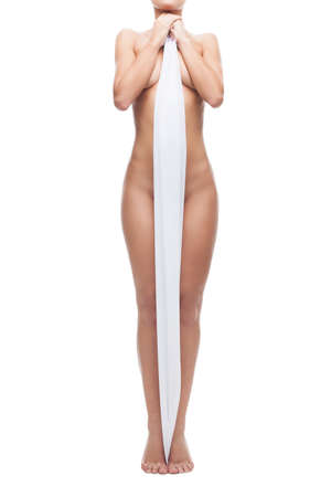 Naked woman. Cropped image of beautiful naked woman covering her body with white cloth while standing isolated on whiteの写真素材