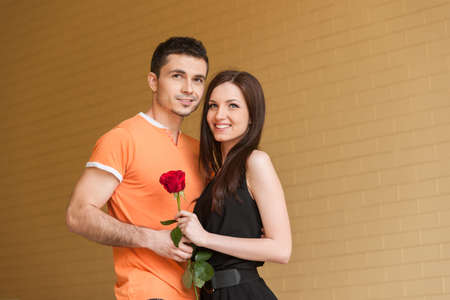 Loving couple. Cheerful young couple hugging while looking away and smilingの写真素材
