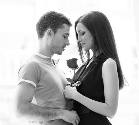 Loving couple. Black and white image of beautiful young couple hugging and smilingの写真素材