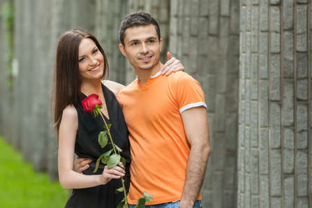 Happy couple. Cheerful young couple hugging while standing outdoorsの写真素材