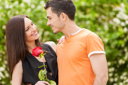 Loving couple. Beautiful young loving couple hugging and looking at each otherの写真素材