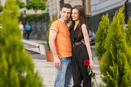 Loving couple. Cheerful young couple hugging and looking awayの写真素材