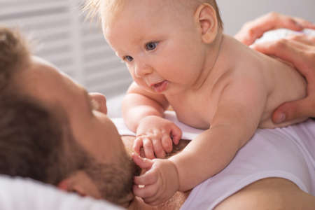 Father and baby. Young father and little baby having fun togetherの写真素材