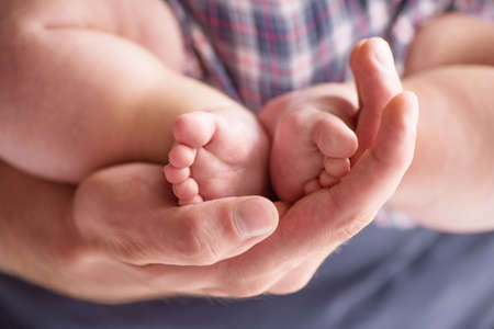 Man with little baby. Young muscular man and little baby lying on the bedの写真素材