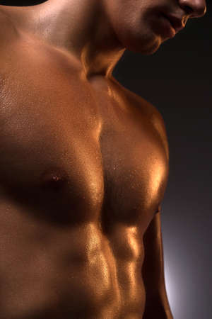 Muscular man. Close-up of muscular man standing isolated on whiteの写真素材