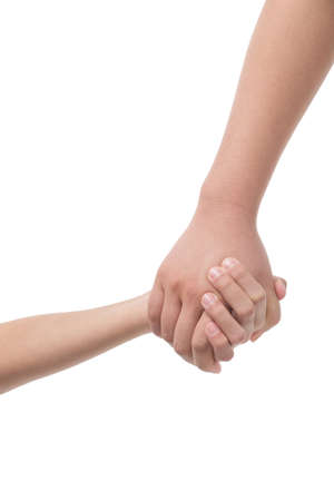 Holding hands. Close-up of child and adult person holding hands while isolated on whiteの写真素材