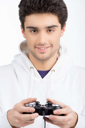 Young man playing video games while isolated on white
