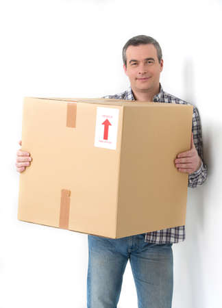 Cheerful middle-aged man holding cardboard box and smilingの写真素材