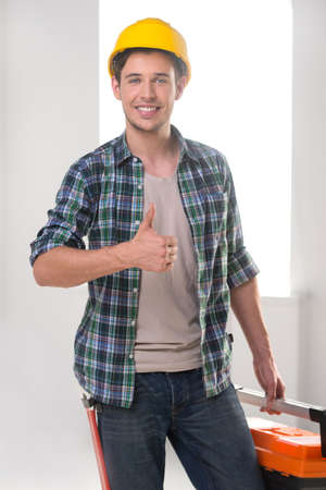 Handyman. Cheerful craftsperson looking at camera and smilingの写真素材