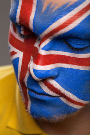 Painted face with Flag of Great Britain. Close-up with closed eyesの写真素材