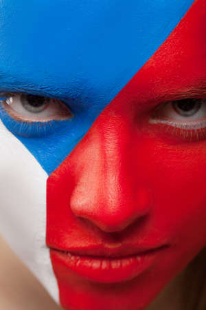 Close up of woman painted face. Painted with red, blue, white colors