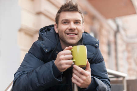 Men drinking coffee  Handsome young men drinking coffee outdoors