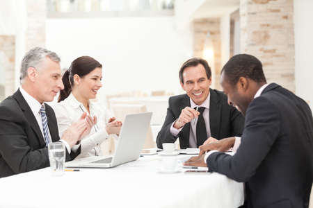 Group Of Happy Coworkers Discussing In Conference Roomの写真素材